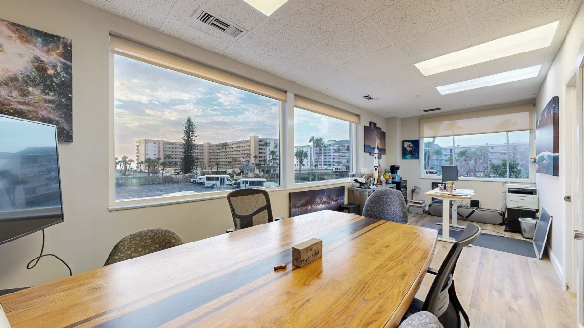 Private office with ocean-view windows and a large wood conference table