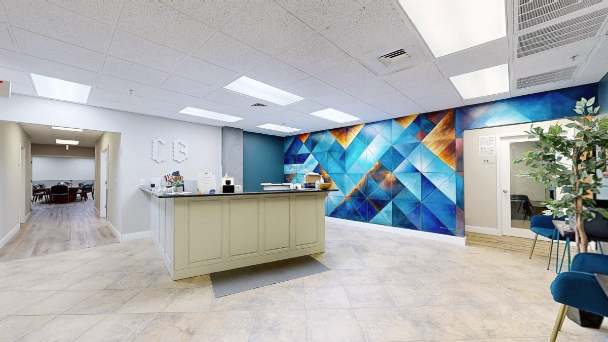 Reception lobby with a hand-painted blue mural