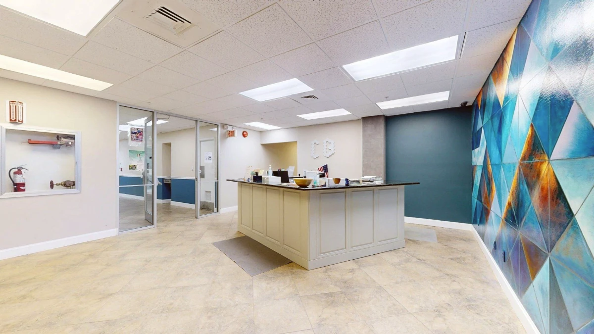 The reception desk and wall mural at Cocoa Beach Office