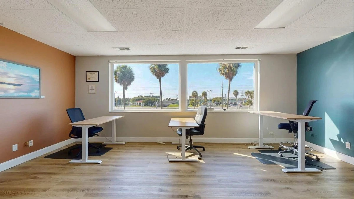 A team suite with three desks and palm-tree views
