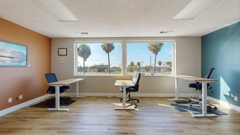 Team suite with three desks and palm views at Cocoa Beach Office